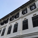 A white residential building with open windows